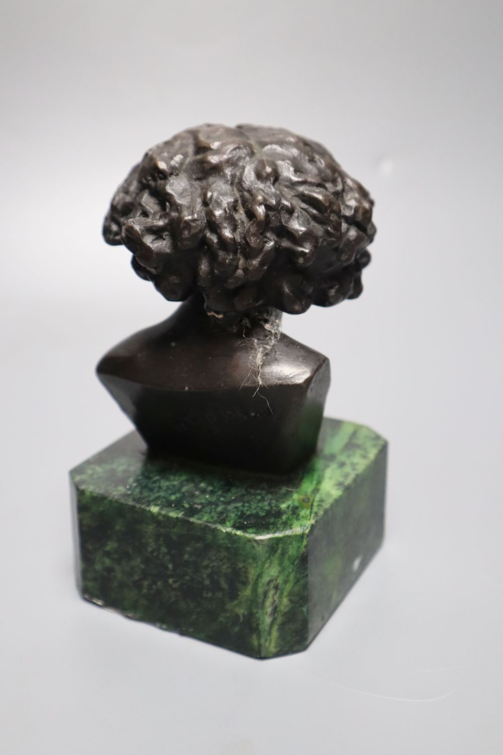 After F Masseau. A bronze bust, on green marble base